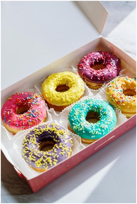 Brightly colored glazed donuts with sprinkles in a
