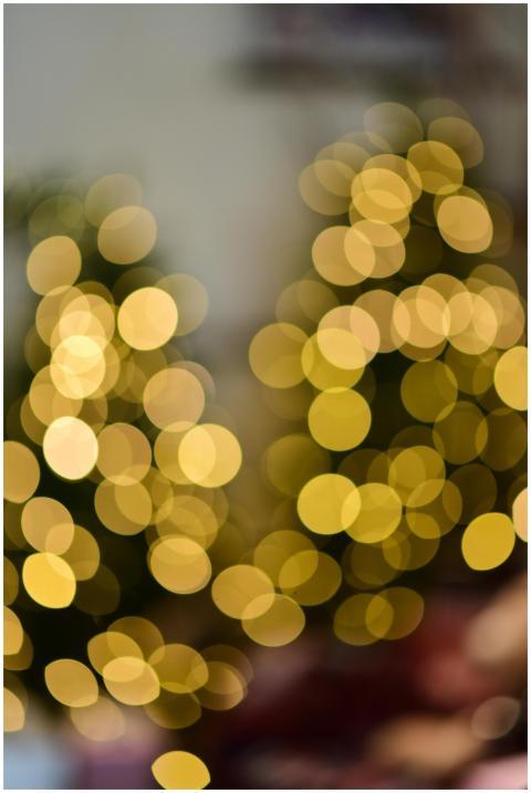 Blurred golden bokeh lights creating a festive hol