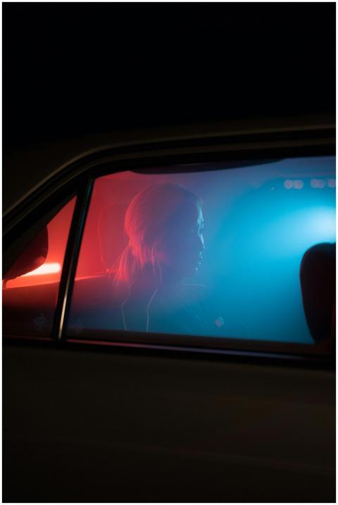 Artistic silhouette of a woman sitting in a car in
