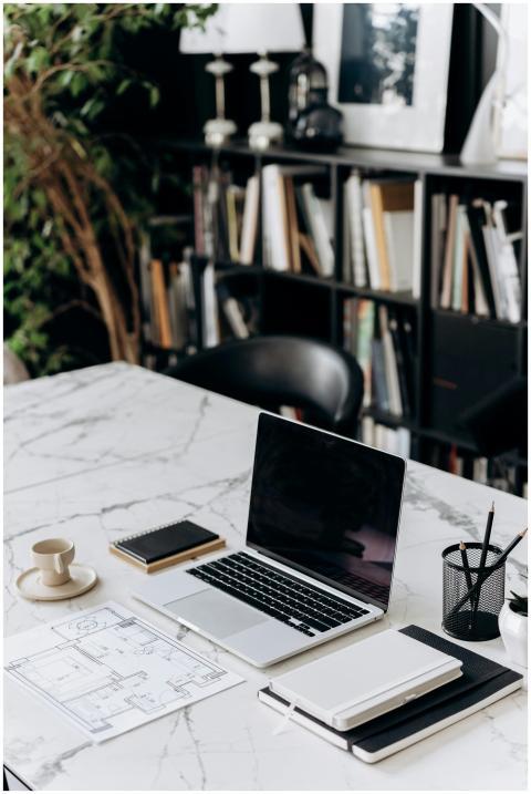 A modern minimalist workspace featuring a laptop,