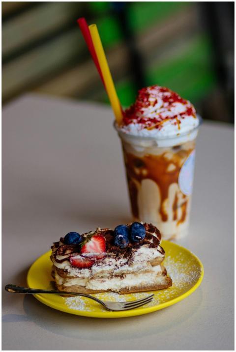 A tempting tiramisu slice with berries and whipped