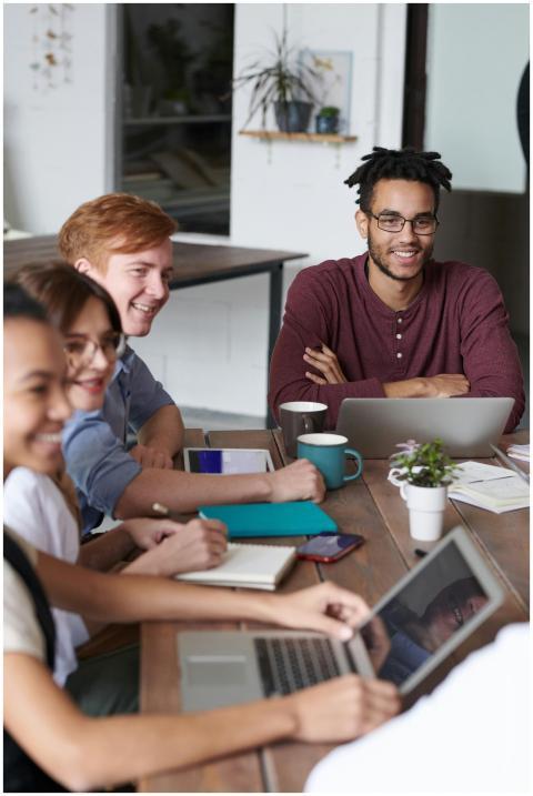 A diverse group of professionals collaborate on la