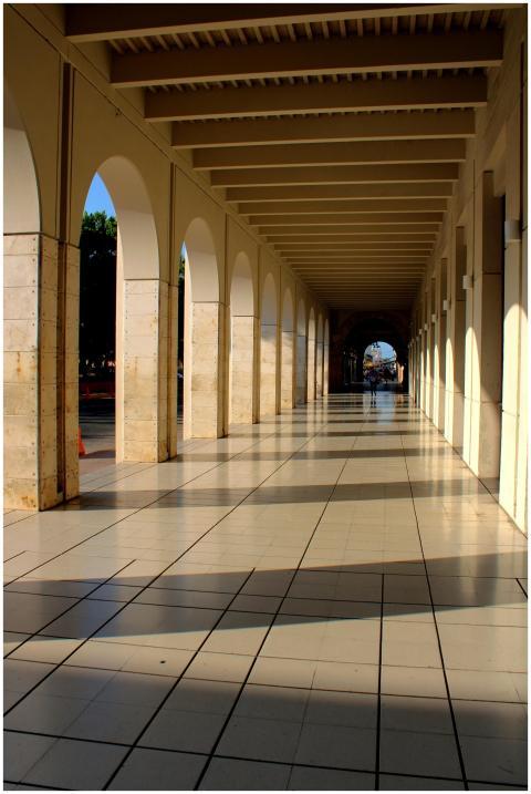 Empty sunlit corridor with arches in Mérida, Mexic
