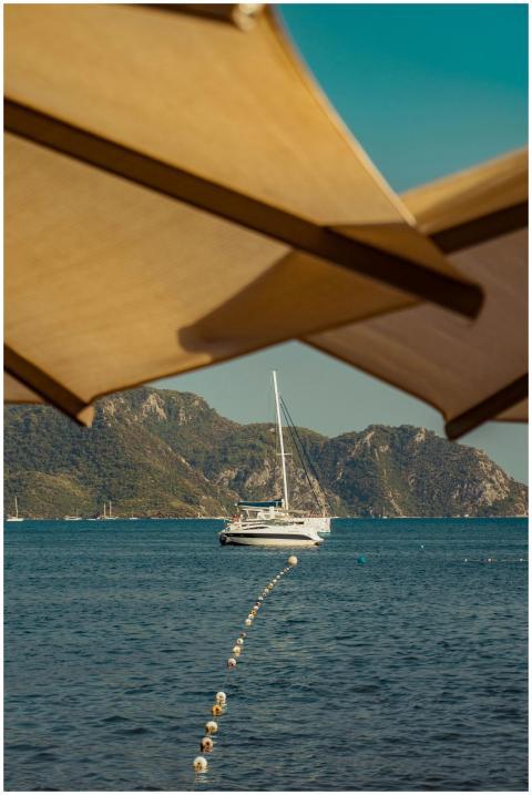 A tranquil view of a sailboat anchored on calm wat
