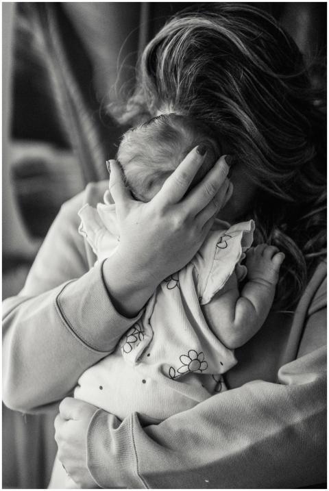 Tender moment captured between mother and baby, di