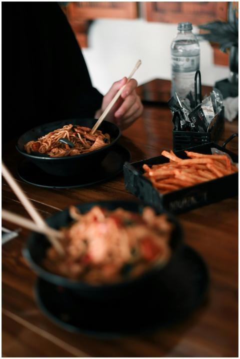 A cozy restaurant scene with noodles and fries on