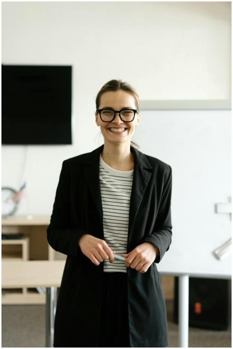 Caucasian woman in black blazer with eyeglasses, s