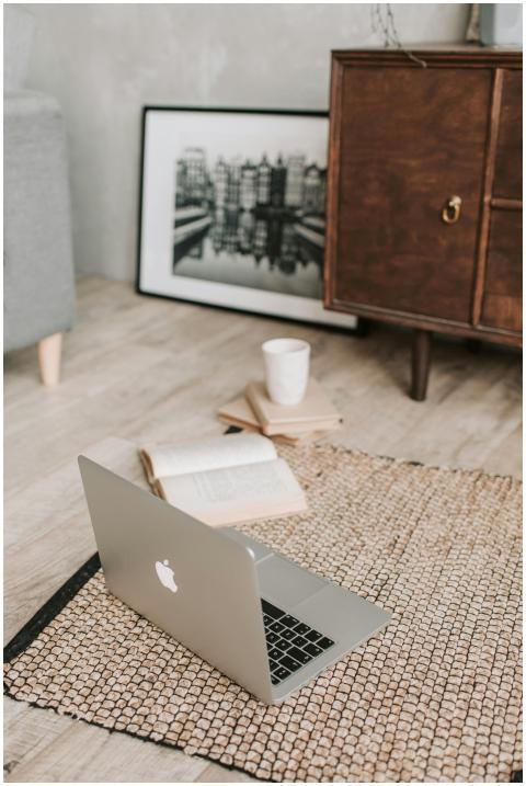 A serene workspace with a laptop, open book, and c
