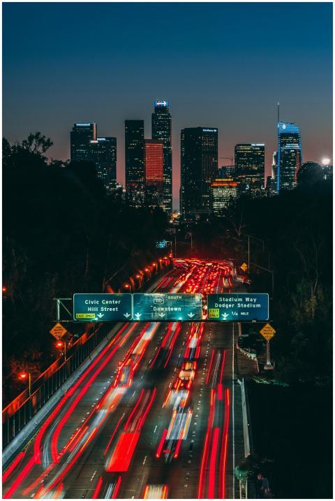 Dynamic Los Angeles skyline at night with light tr
