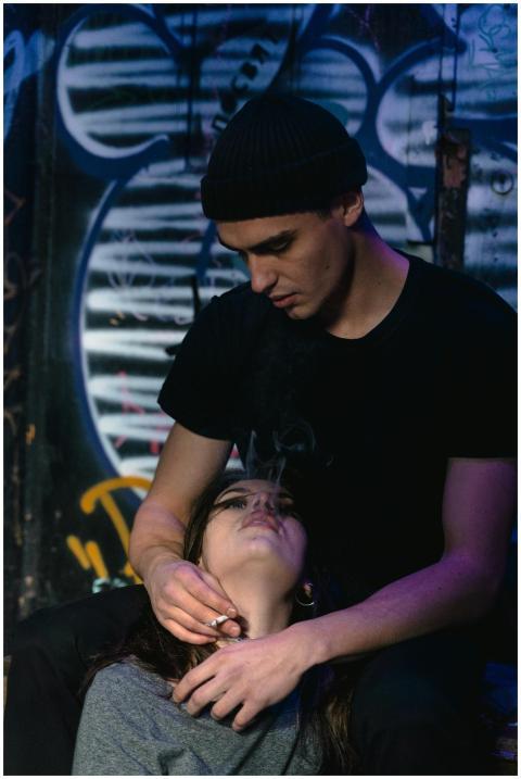 Couple in an urban setting with graffiti art, evok