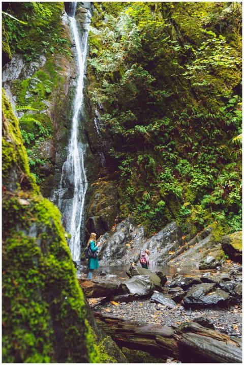 Mom and daughter enjoy a picturesque waterfall in