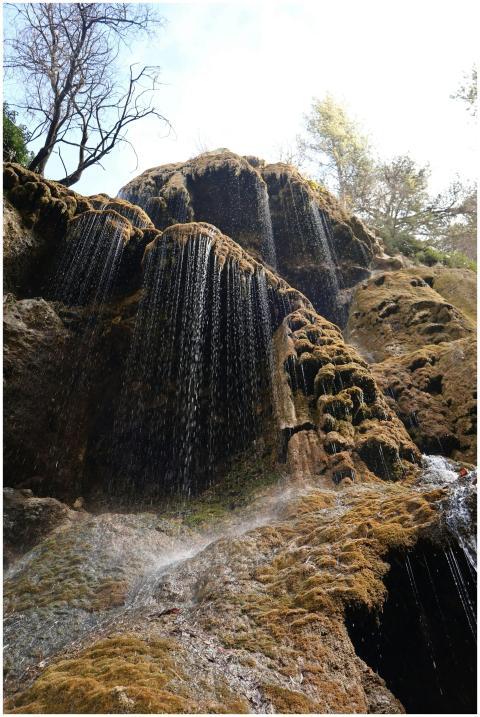 A breathtaking waterfall cascading down moss-cover