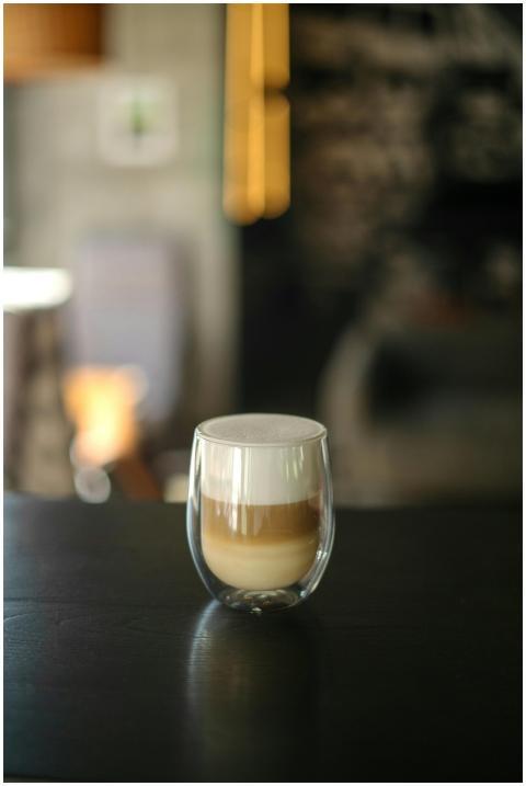 Stylish cappuccino in a double-walled glass on a d