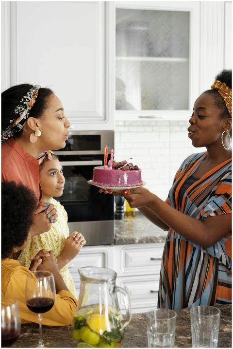 Family celebrating a birthday in the kitchen with