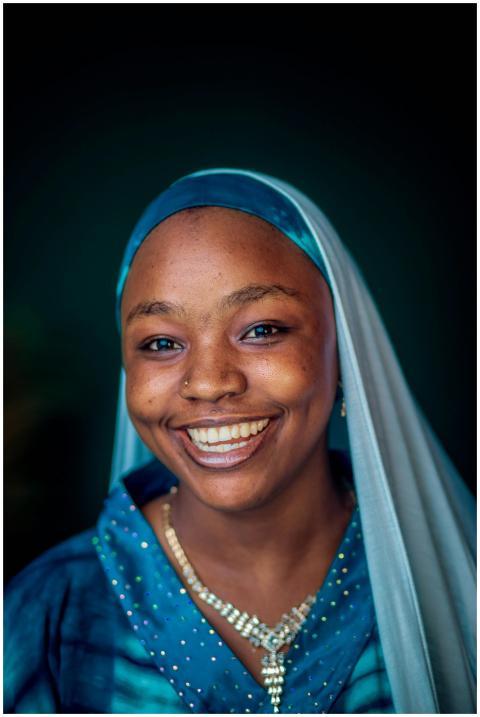 Close-up portrait of a smiling woman in blue tradi