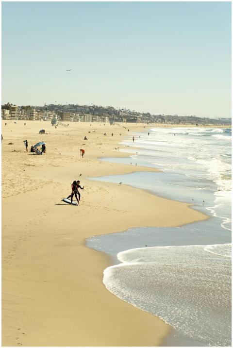 A serene beach scene featuring surfers and gentle