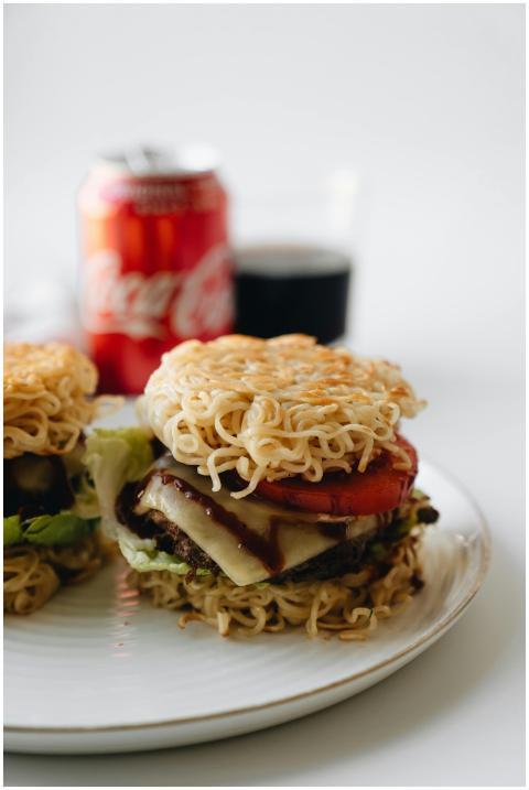 Close-up image of a unique ramen burger with chees
