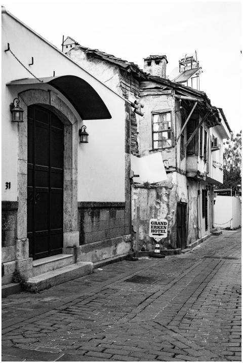 A black and white photo of a rustic street featuri