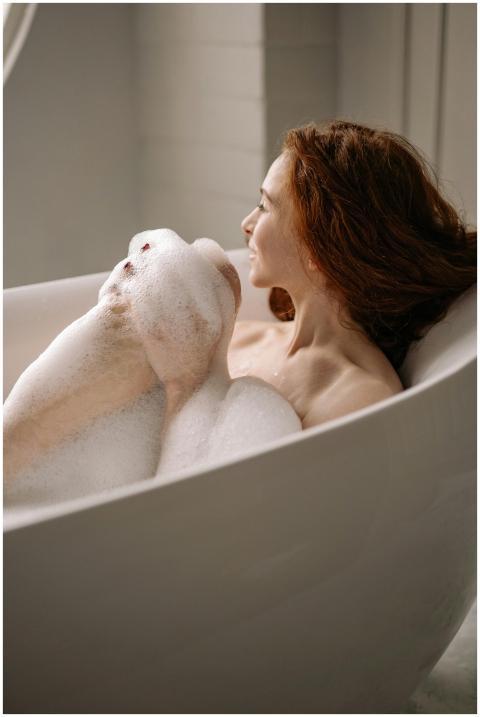 A serene moment of a woman with red hair enjoying