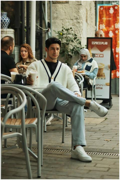 Casual outdoor cafe seating with diverse group enj