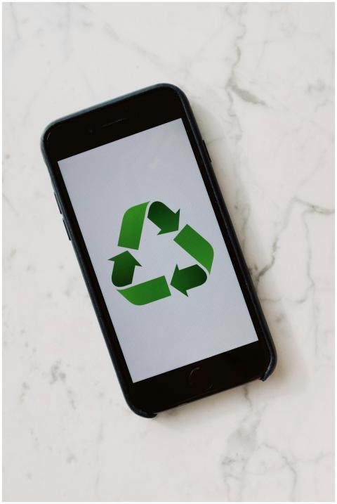 Smartphone placed on marble surface displaying gre