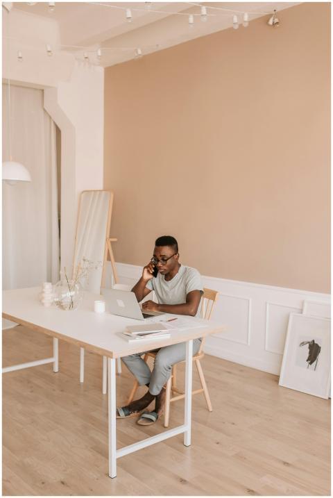 Man working remotely in a minimalist home office,