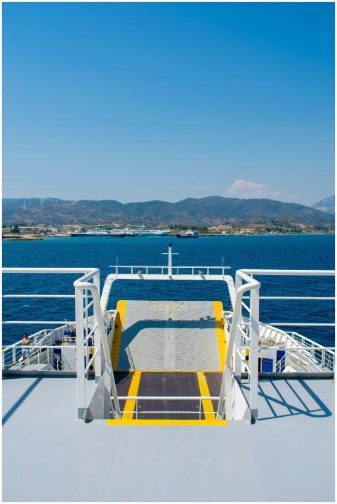 A ferry ramp leading to the bright blue waters of