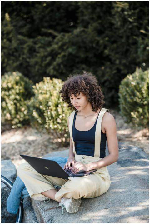 A young woman with curly hair enjoys working on he