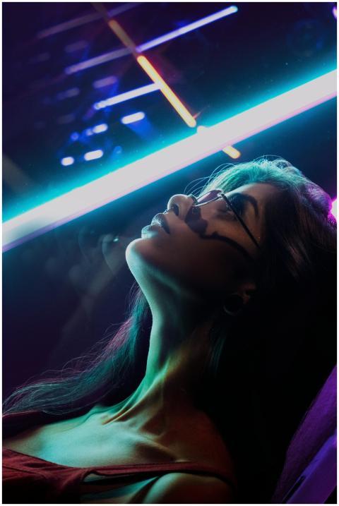 Artistic portrait of a woman with neon lights in S