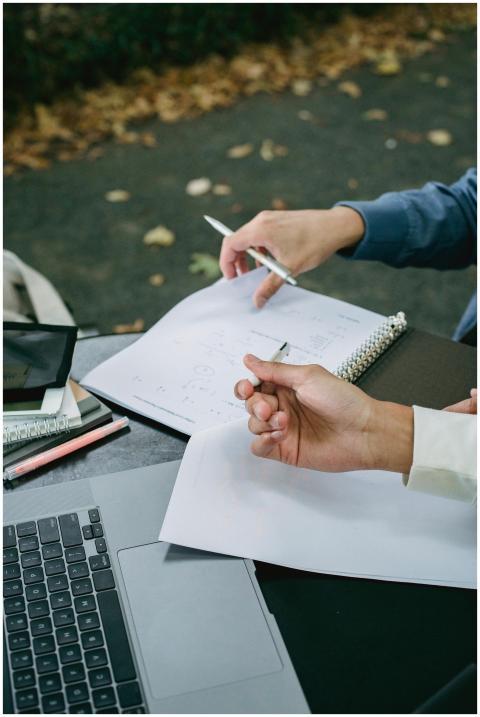 High angle of crop anonymous male students using l