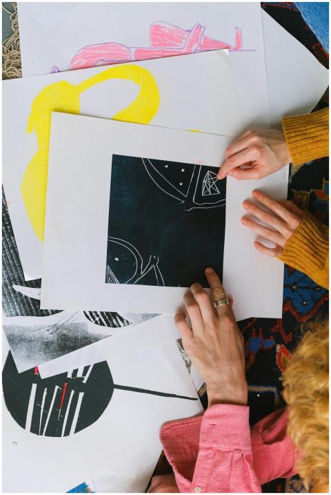 From above of unrecognizable artists working on ne