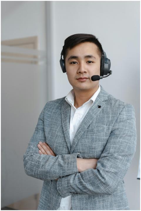 Asian male call center operator wearing a gray sui
