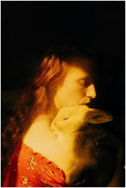A serene portrait of a woman embracing a rabbit, i