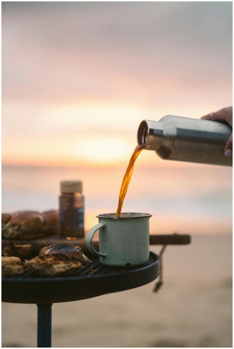 A serene beachside scene with coffee being poured