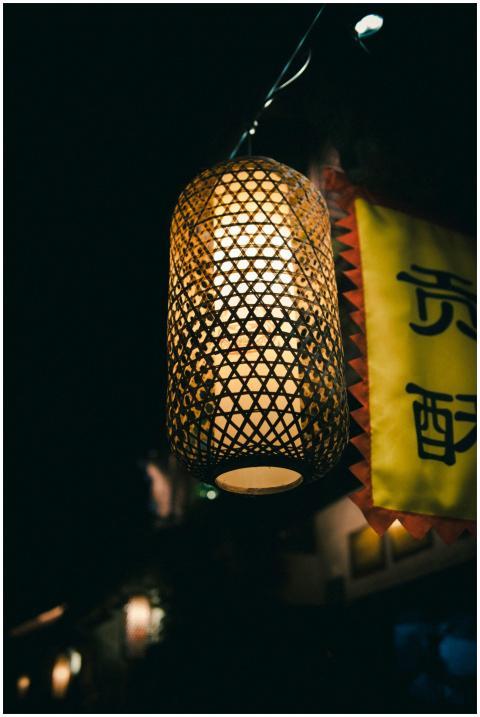 A beautifully crafted lantern hangs glowing at nig