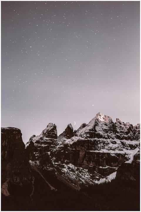 Majestic snow-covered mountain peaks illuminated u
