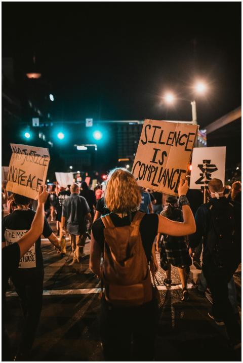 Activists gather at night for a protest in the cit