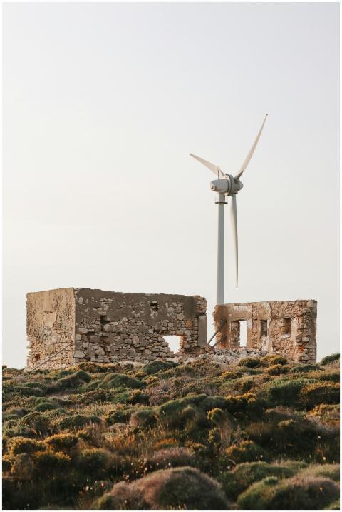 Historic ruins with a wind turbine, symbolizing su
