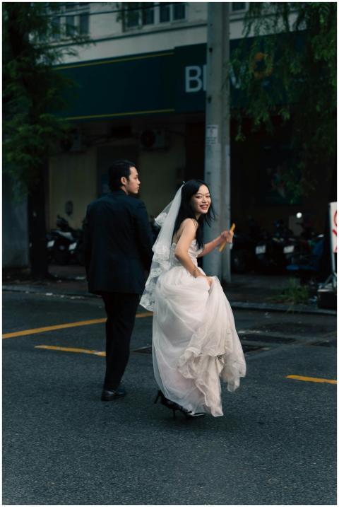 Joyful bride and groom in wedding attire walking o