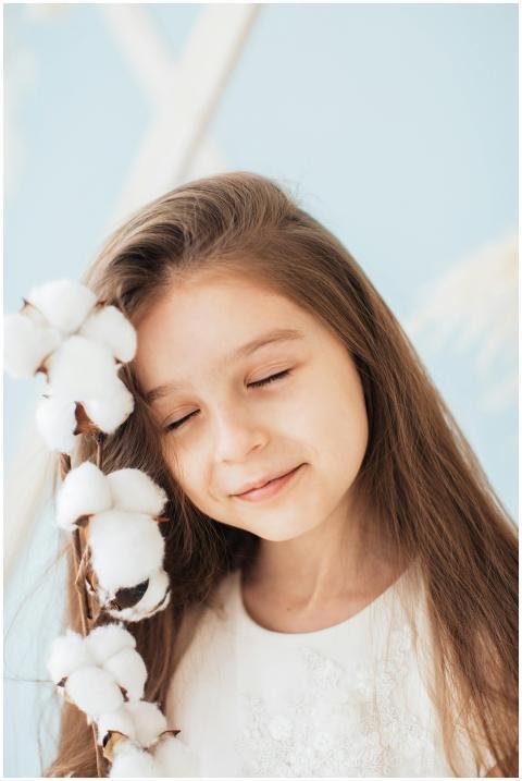 Charming portrait of a young girl smiling with cot