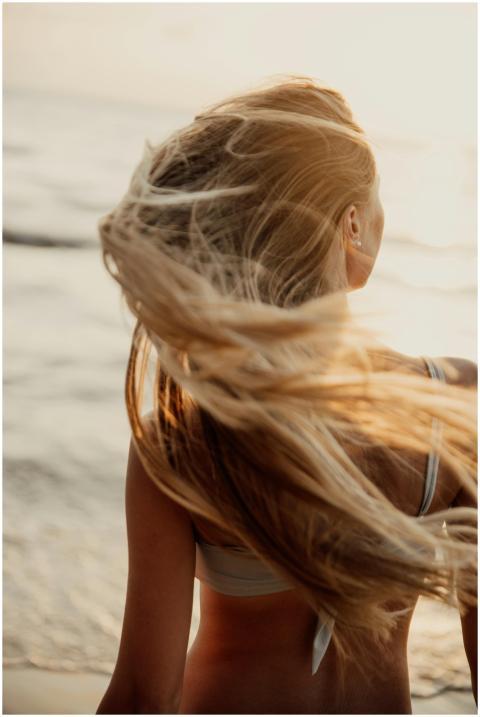 A young woman enjoying a breezy day on a Bali beac