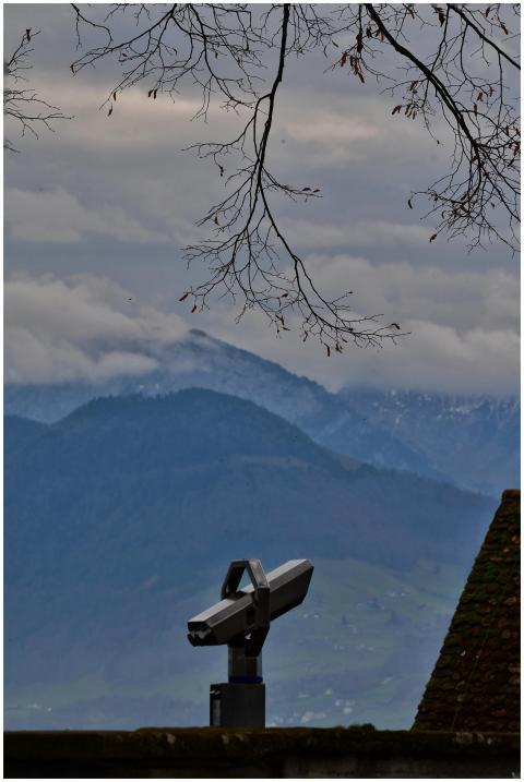 Telescope overlooking misty mountain range, under