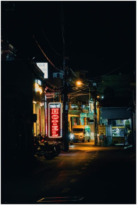 A vibrant urban street at night with neon lights a