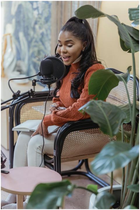 African American woman recording a podcast in an i