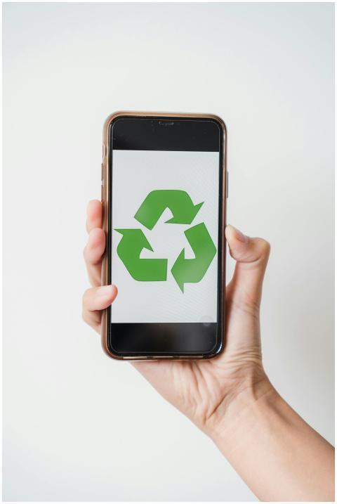 Close-up of hand holding smartphone displaying gre