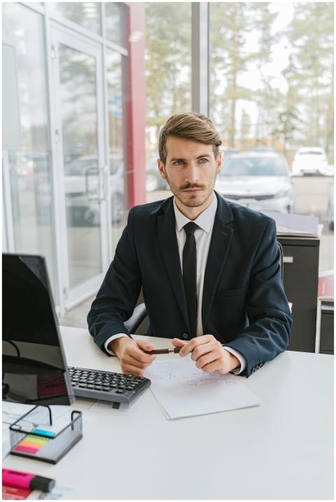 Professional businessman in a suit sitting at a de