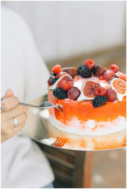 Close-up of a fruit-decorated cake with cream and