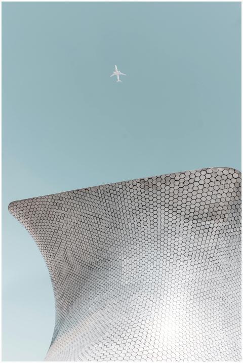 From below shot of passenger airplane flying in cl