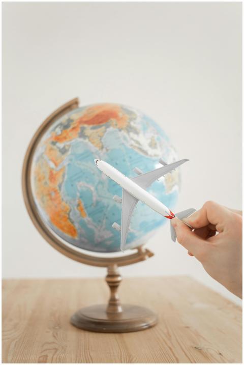 Close-up of a hand with a toy airplane in front of