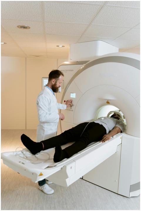 Doctor operating MRI scanner for patient examinati